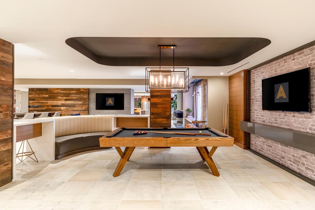 A room with a pool table and a fireplace.