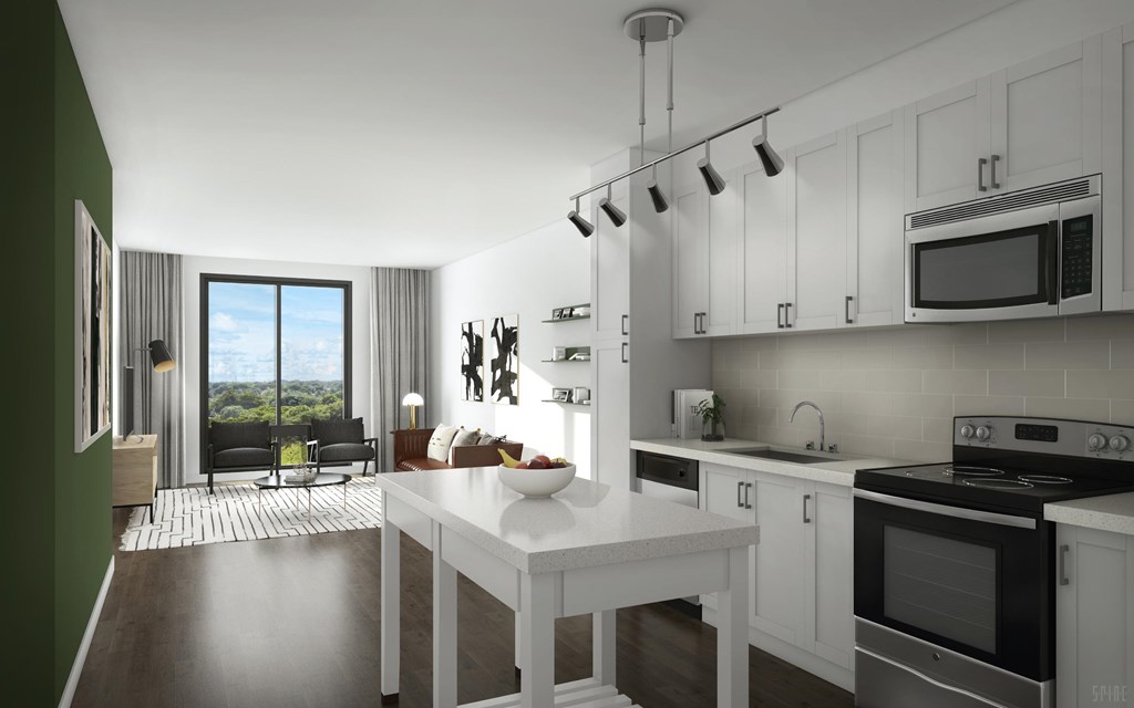 A modern kitchen with white cabinets and a large island.