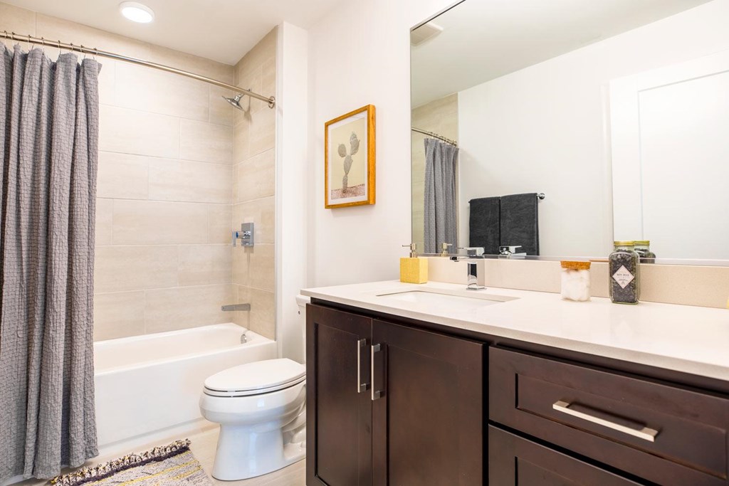 A bathroom with a toilet, sink, and shower.