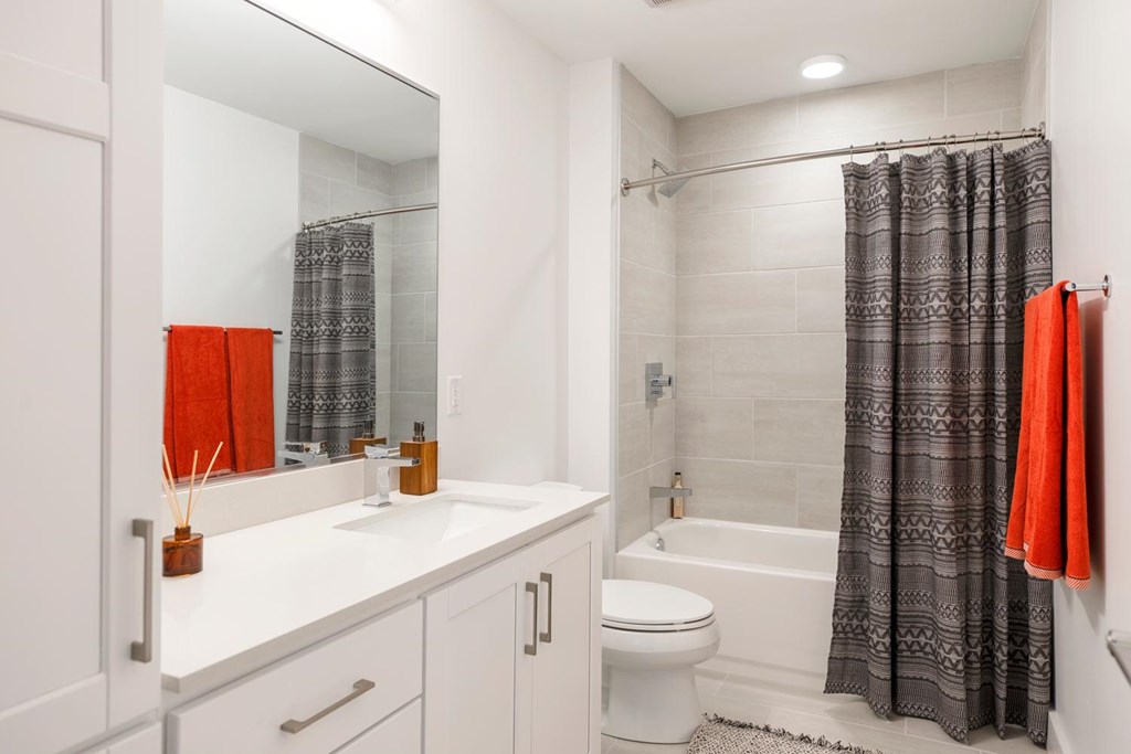 A white bathroom with a white toilet and a white sink.