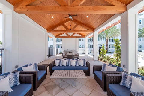 A patio with a wooden ceiling and blue couches.at Corban Freedom Apartments, Orlando, FL
