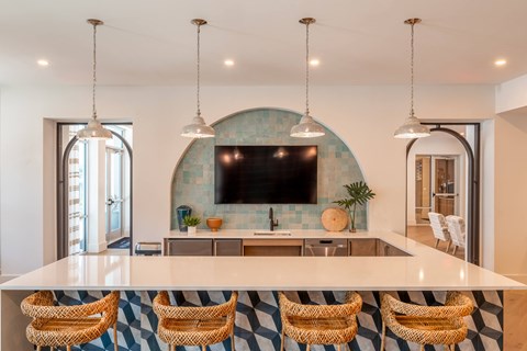 Resident lounge at Corban Freedom Apartments in Orlando, FL, featuring a flat screen TV and counter seating.