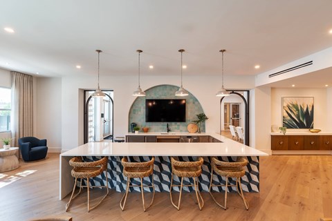 Resident lounge at Corban Freedom Apartments in Orlando, FL, featuring a flat screen TV and counter seating.