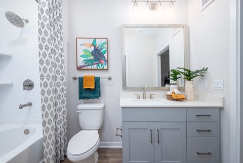 A white toilet sits next to a white sink in a bathroom.at Corban Freedom Apartments, Florida, 32837