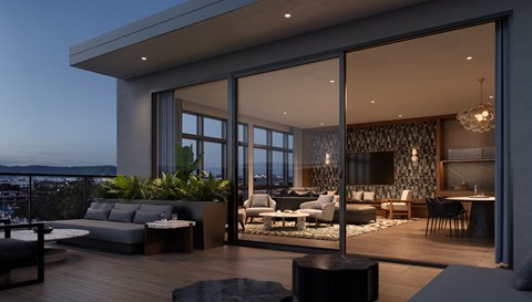A modern living room with a view of the city at dusk.