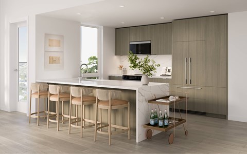 A modern kitchen with a bar area and stools.