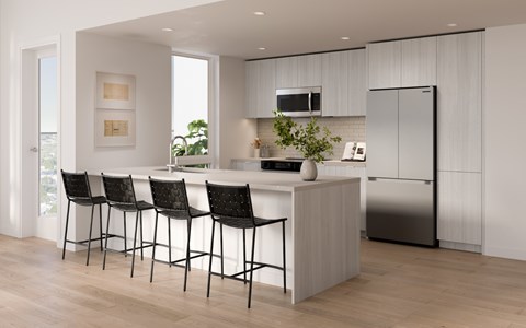 A modern kitchen with a bar area and chairs.