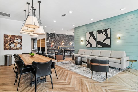 A modern dining room with a wooden table and chairs.