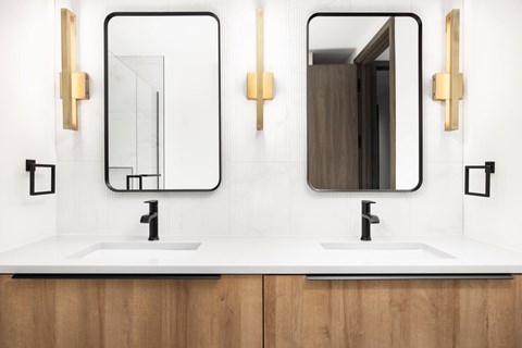 A bathroom with two sinks and two mirrors.
