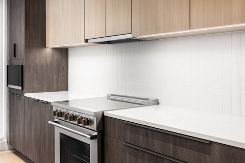 A modern kitchen with a stove top oven and a microwave.