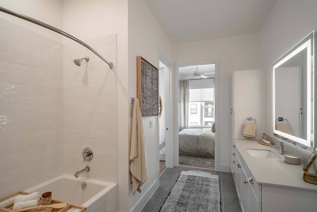 A white bathroom with a white tub and sink.