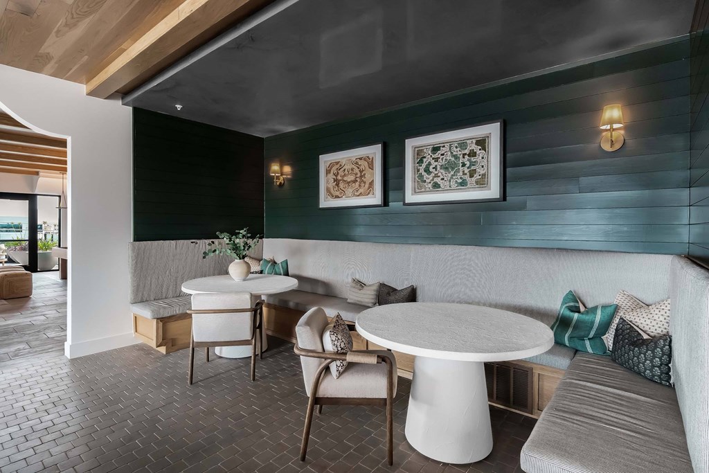 A modern dining area with a white table and chairs.