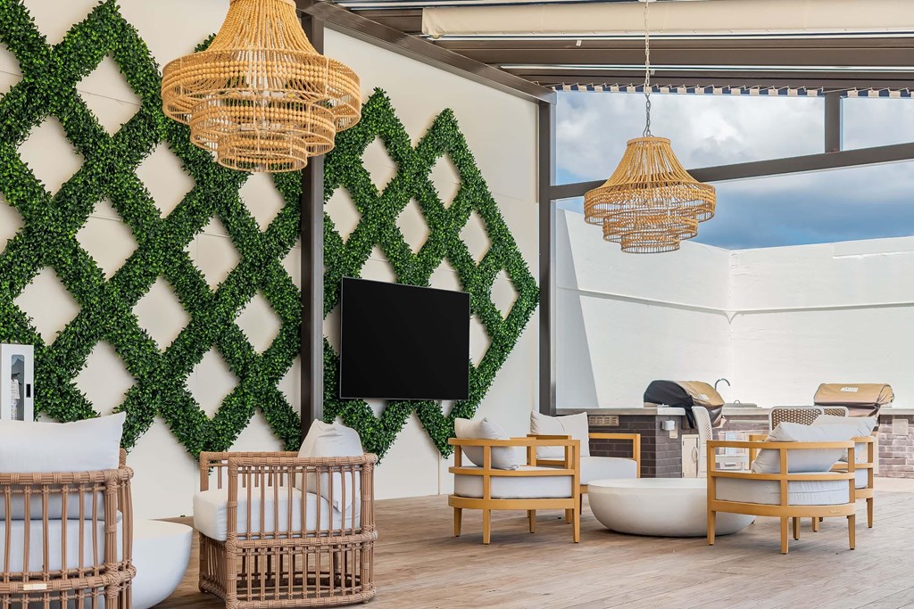 A living room with a flat screen TV and a green wall.