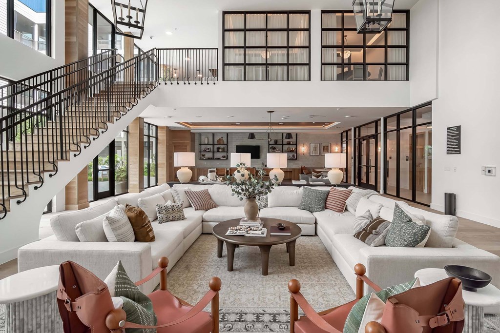 A living room with a staircase and a couch.