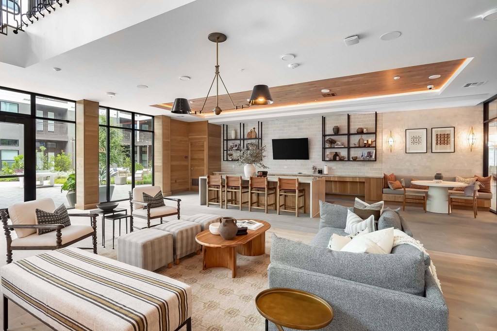 A living room with a grey couch and a wooden coffee table.