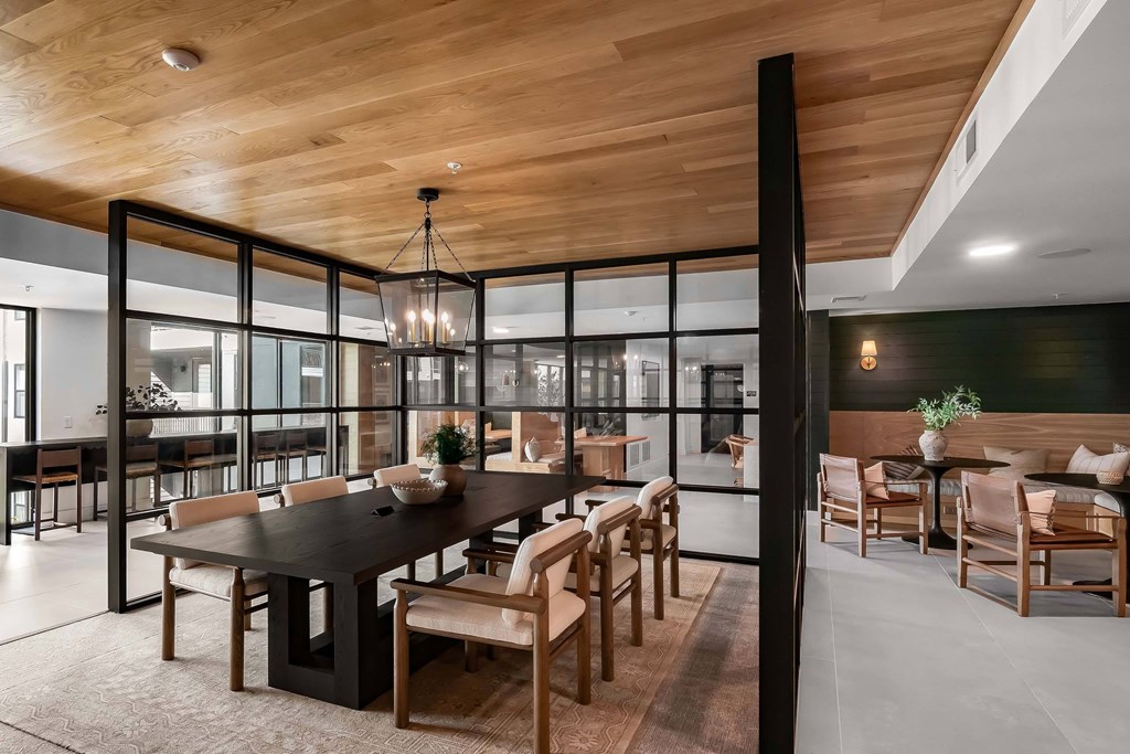 A modern dining room with a large table and chairs.