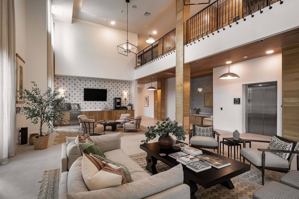 A living room with a white sofa and a wooden coffee table.