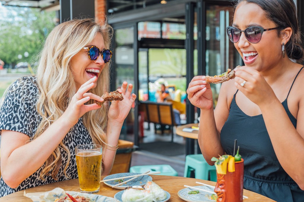Two women eating at a restaurant.