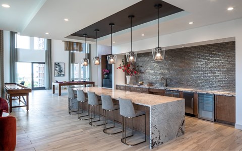 A kitchen with a bar area and a dining table.