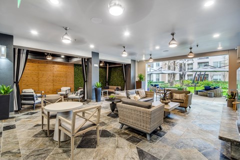 A spacious outdoor patio area with furniture and a view of the city.