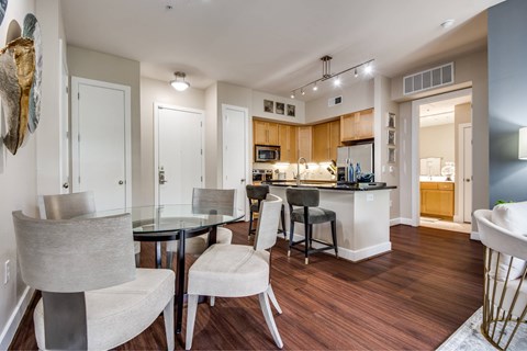 A modern kitchen with a dining table and chairs.