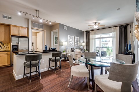 A modern kitchen with a dining table and chairs.