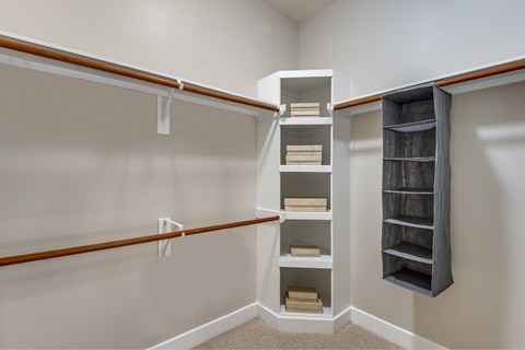 A white closet with shelves and drawers.