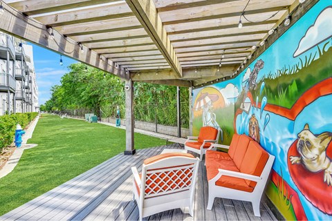 A patio with a mural of a dog and a hot air balloon.