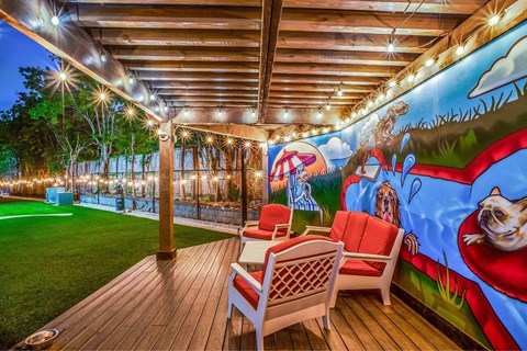 A patio with a mural of a dog and a hot air balloon.