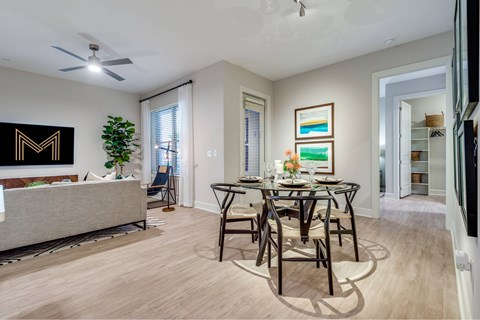 A dining room with a table set for six.