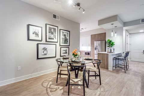 A dining room with a table set for four.