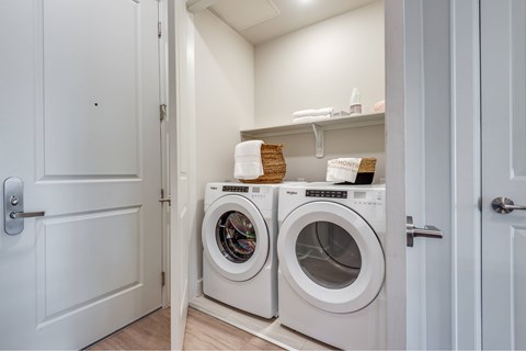 A small laundry room with a washer and dryer.