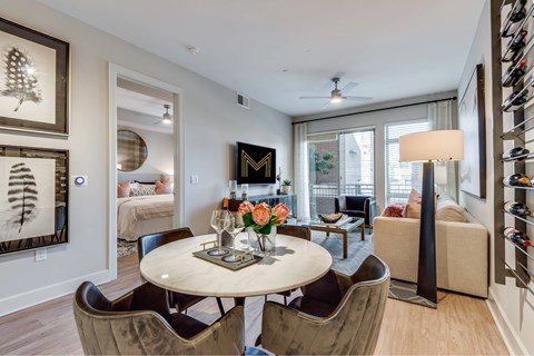 A living room with a white table and chairs.