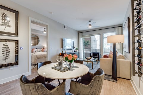 A well-lit dining room with a round table and chairs.