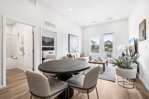 A modern dining room with a round table and chairs.