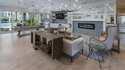 A modern living room with a pool table and a fireplace.