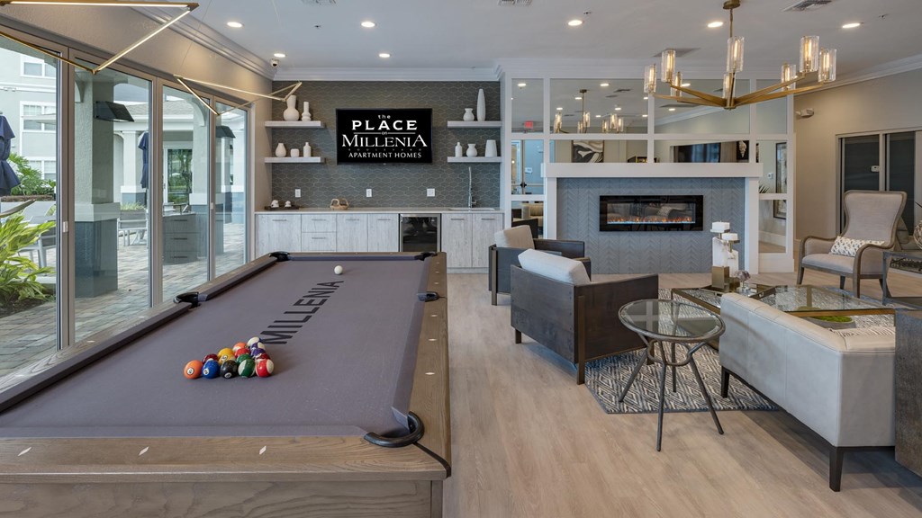 A pool table with balls on it in a room with a fireplace.