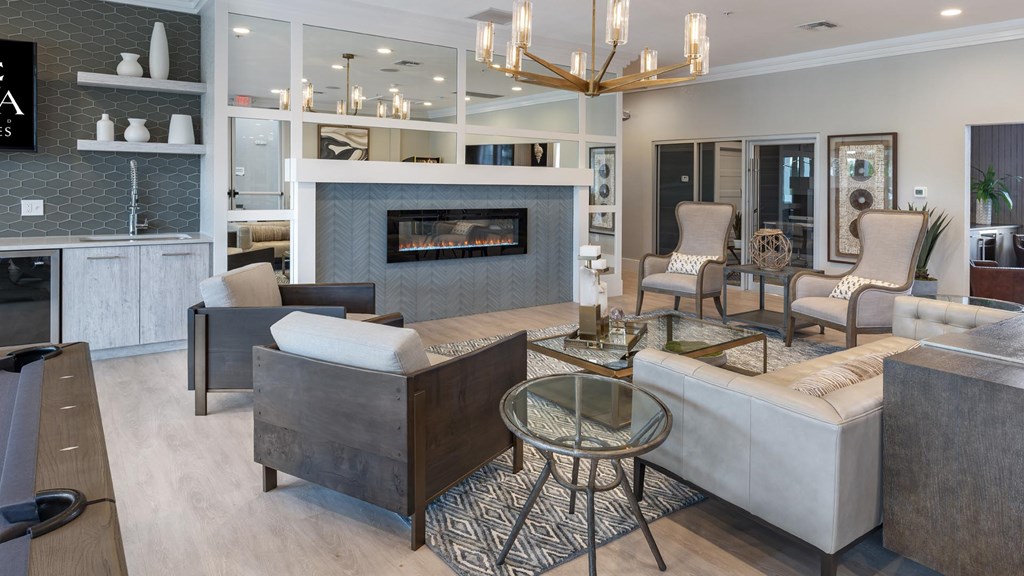 A modern living room with a fireplace and a glass coffee table.