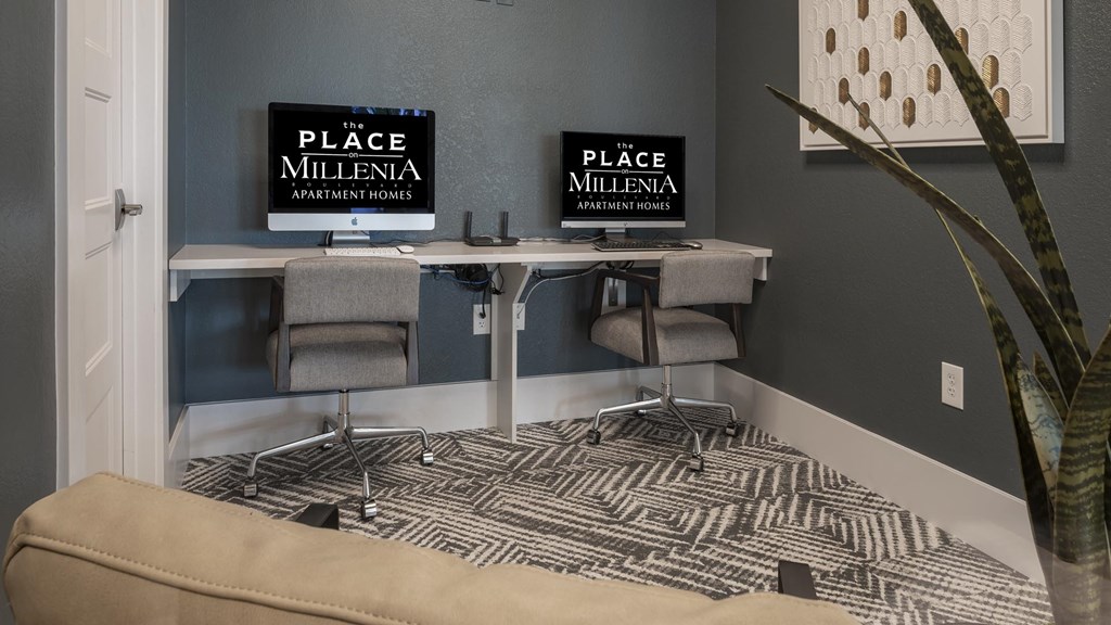 A room with a desk and a couch with a sign that says "The Place Millenia Apartment Homes".