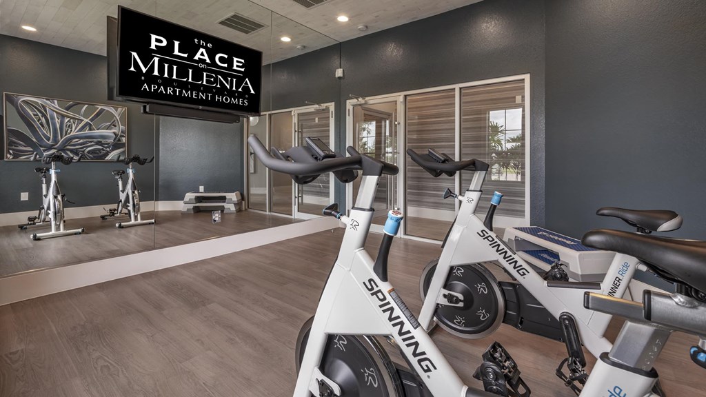 A gym with a Spinning bike in the foreground.