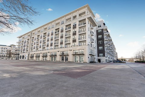 A large white building with many windows and balconies.