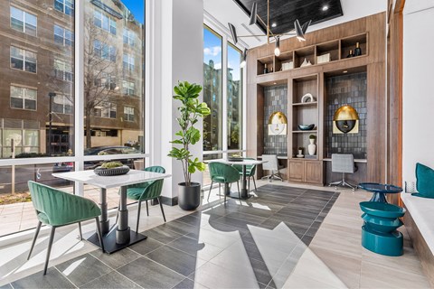 A modern living room with a dining table and chairs.
