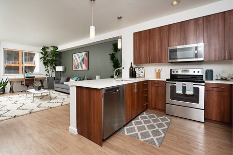 A modern kitchen with wooden cabinets and stainless steel appliances.