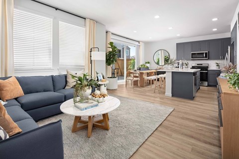 A modern living room with a blue sofa and a coffee table.