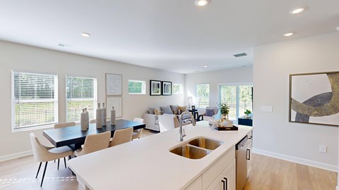 A kitchen with a dining table and chairs.