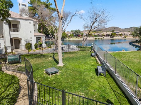 A house with a white exterior and a green lawn.