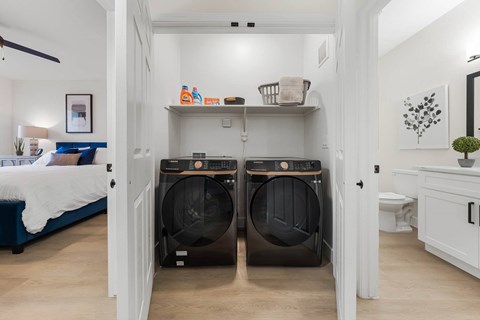 A laundry room with two front-loading washing machines.