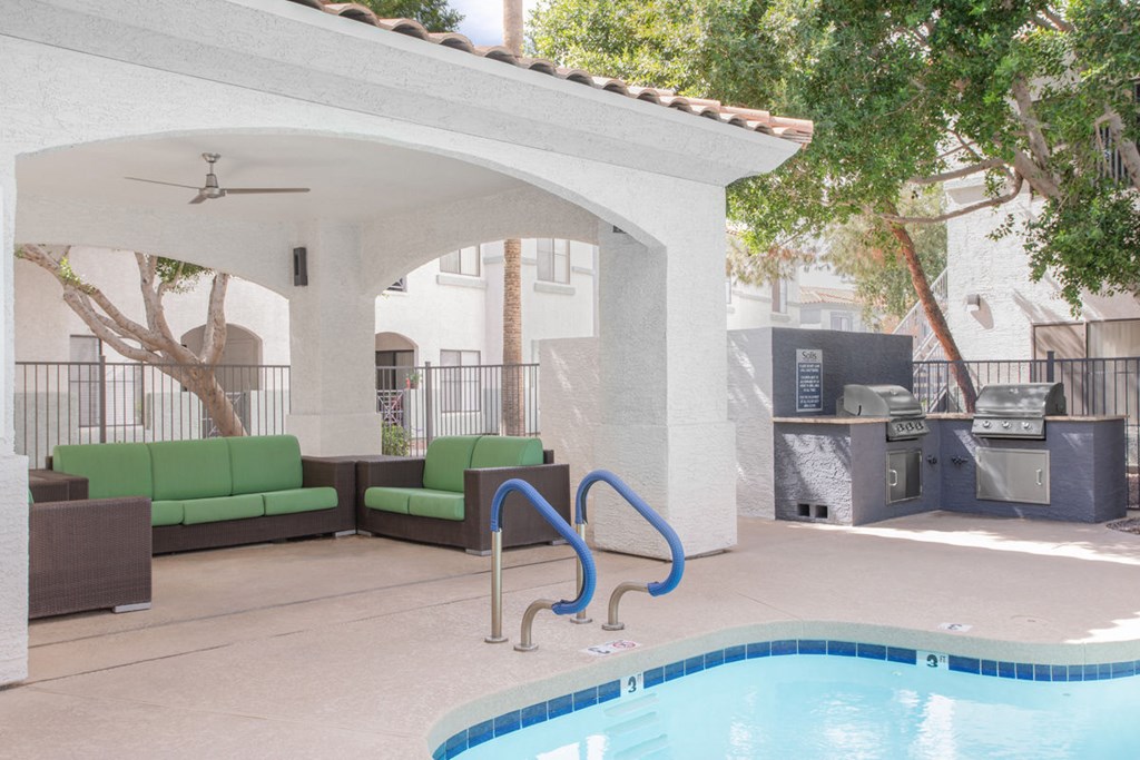 A pool with a slide and a white building in the background.