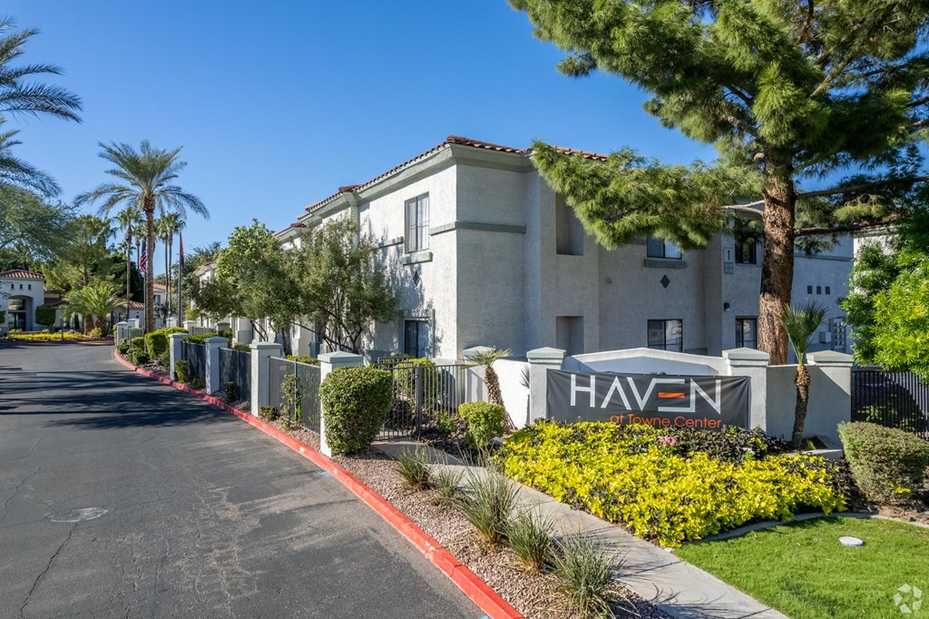A street view of a residential area with a sign that reads "HAVEN".