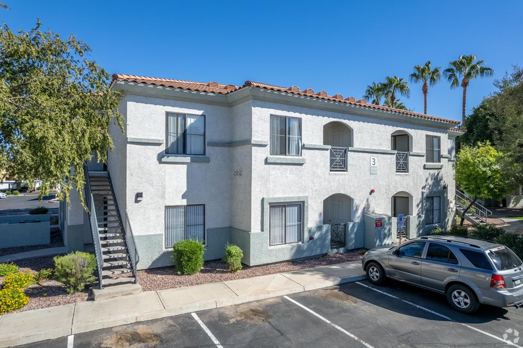 A building with a car parked in front of it.